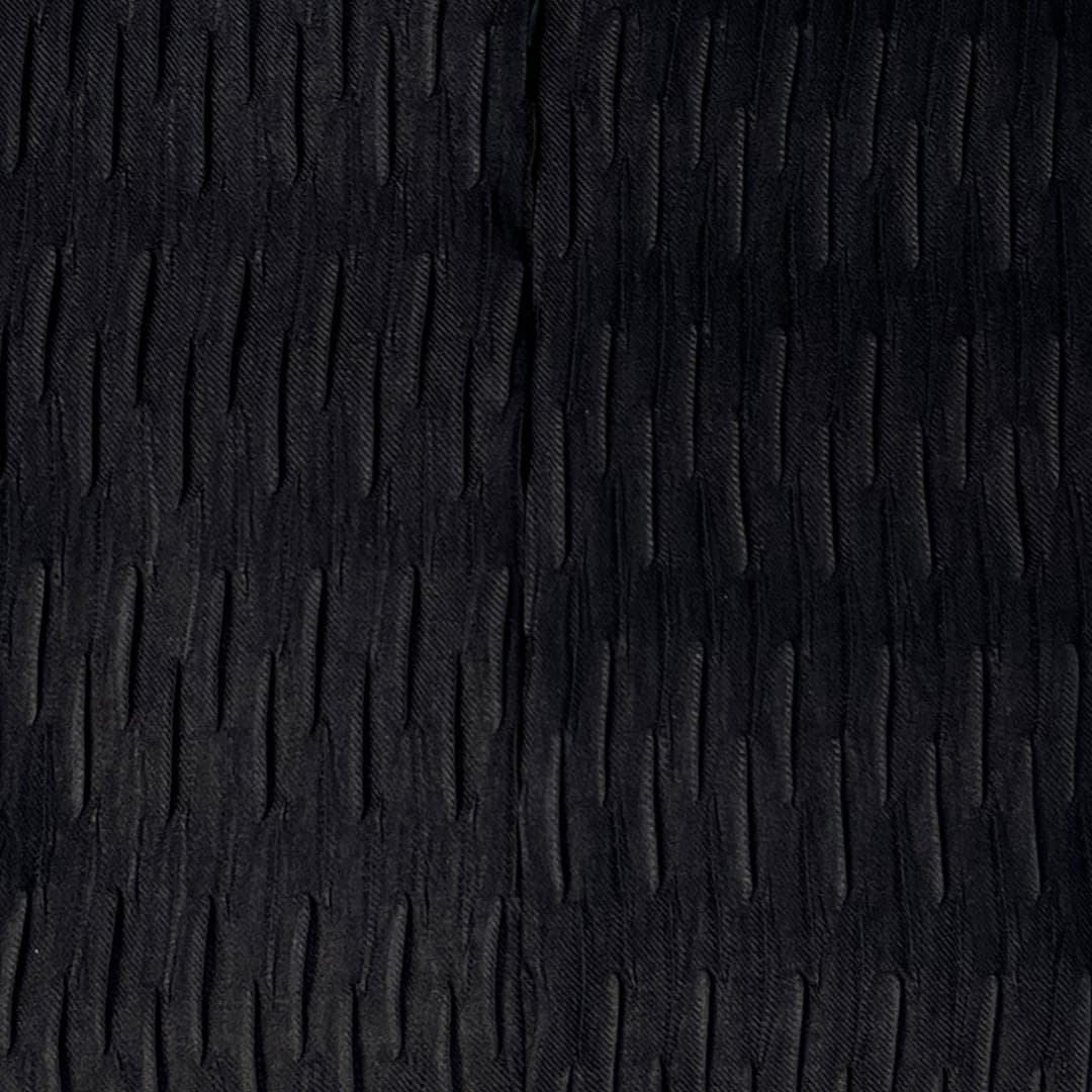 Close-up of an ABYA Lume abaya — pleats premium texture